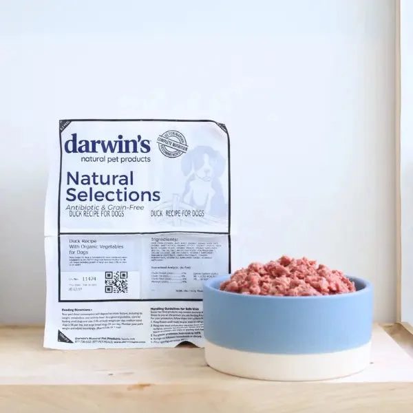Darwin's Natural Selections Duck Recipe for Dogs frozen raw food package next to a bowl of raw duck